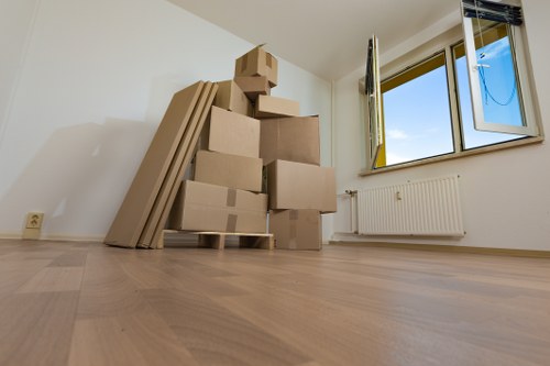 Local moving team organising labelled boxes for a Crayford move